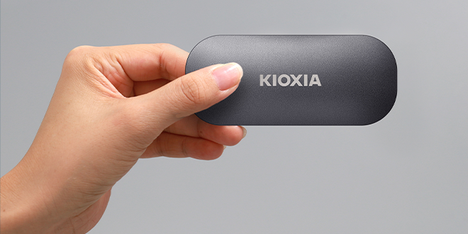 A hand holding a portable SSD